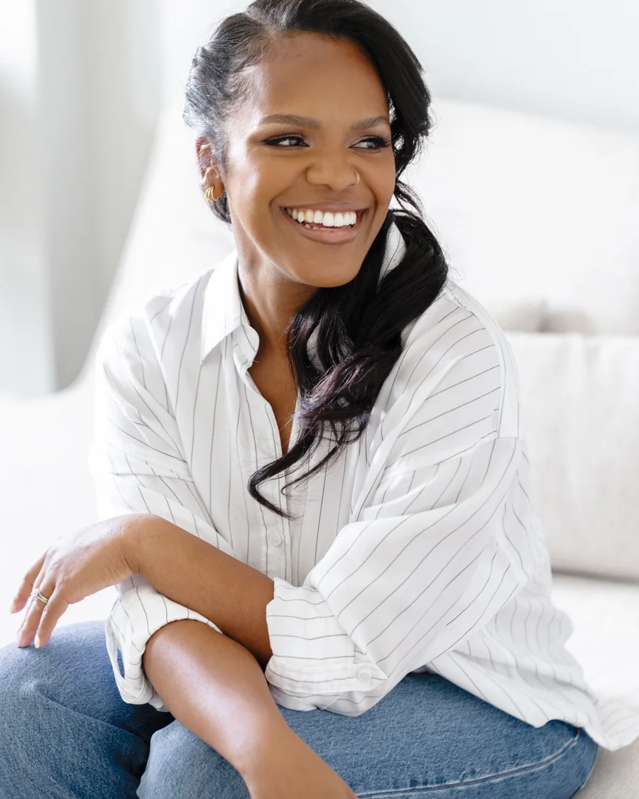 Karina Jackson, seated in a bright room, laughing
